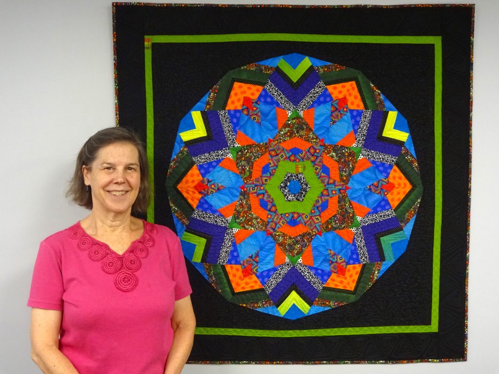 Picture of Wendy Frieden and her "Kaleidoscope Quilt".